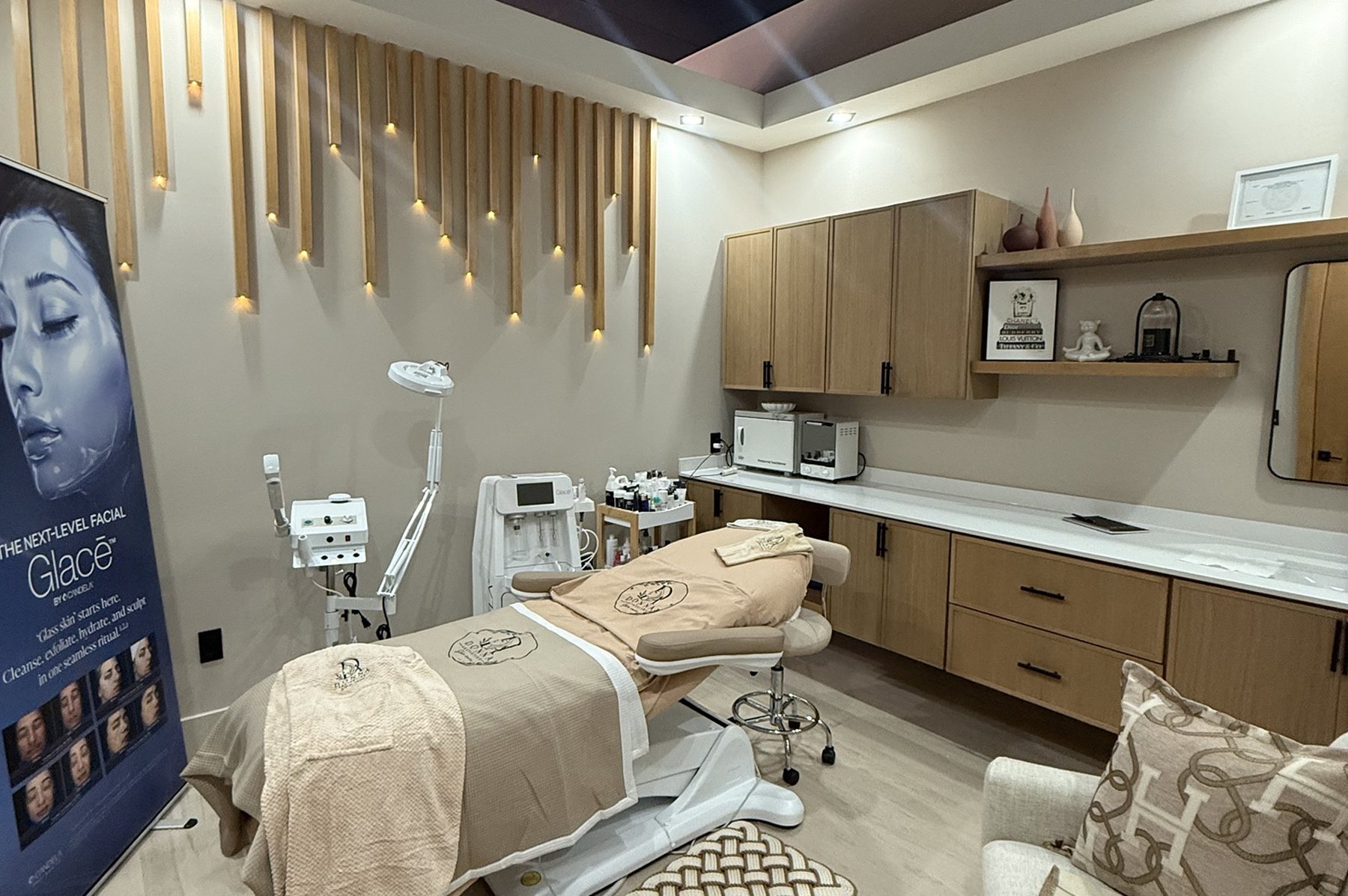 A facial treatment room at Donna Aesthetics, with lit white oak slats on the wall